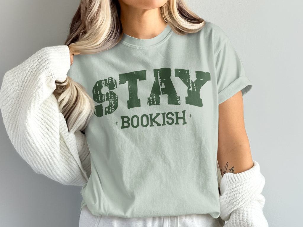 Light green t-shirt with distressed green text that reads "STAY BOOKISH".