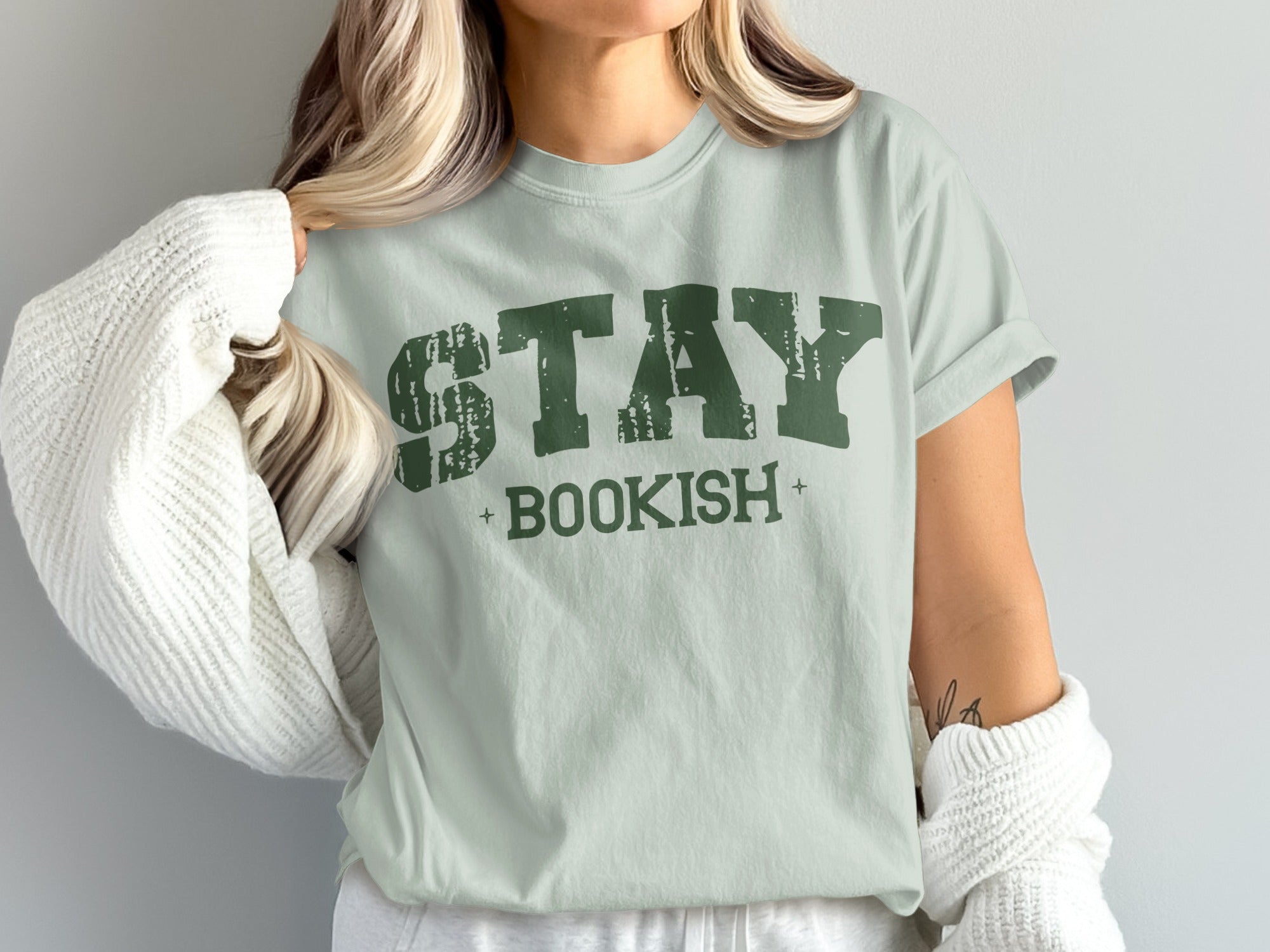 Light green t-shirt with distressed green text that reads "STAY BOOKISH".