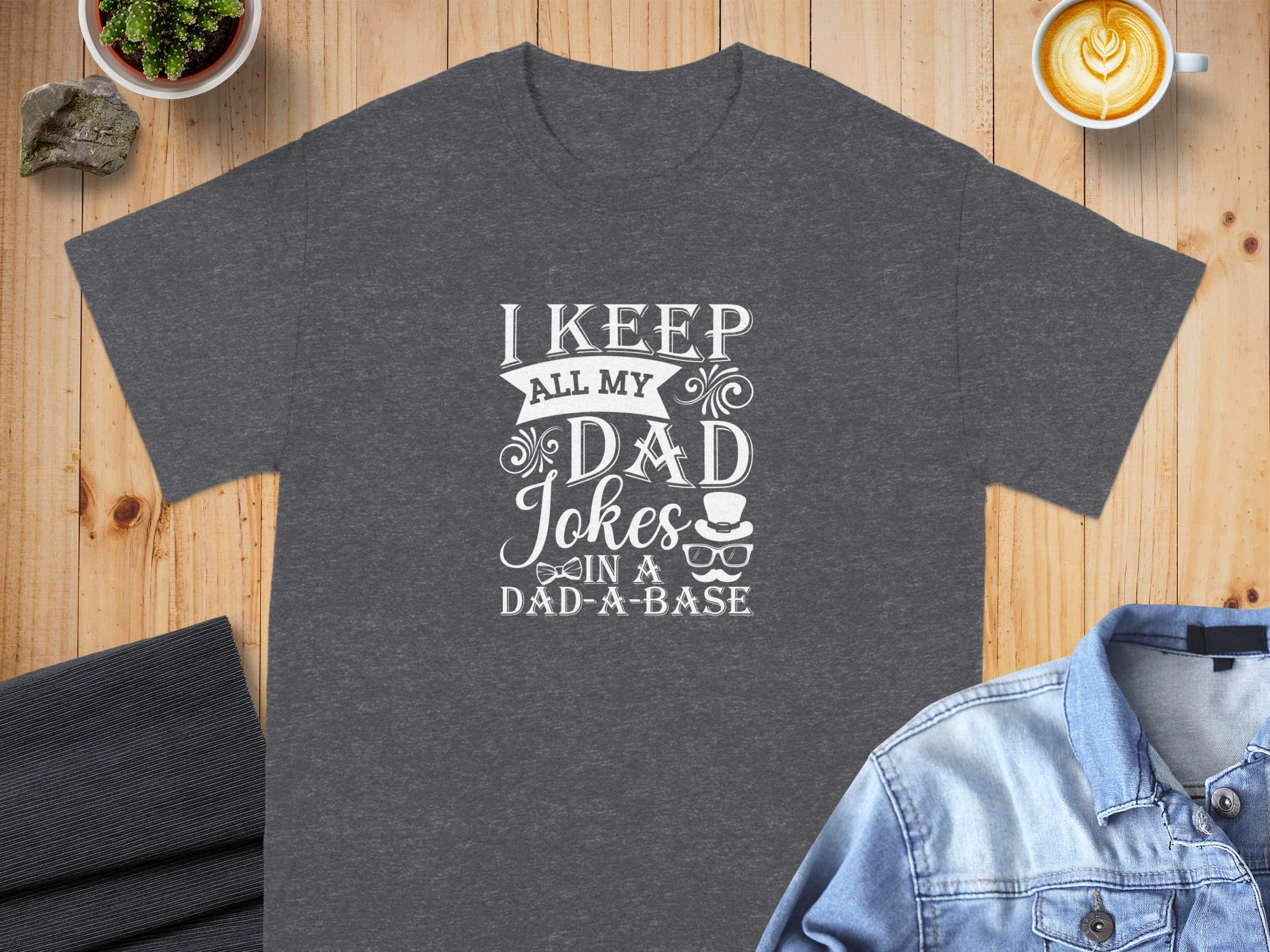 Dark grey t-shirt with white text "I keep all my dad jokes in a dad-a-base".