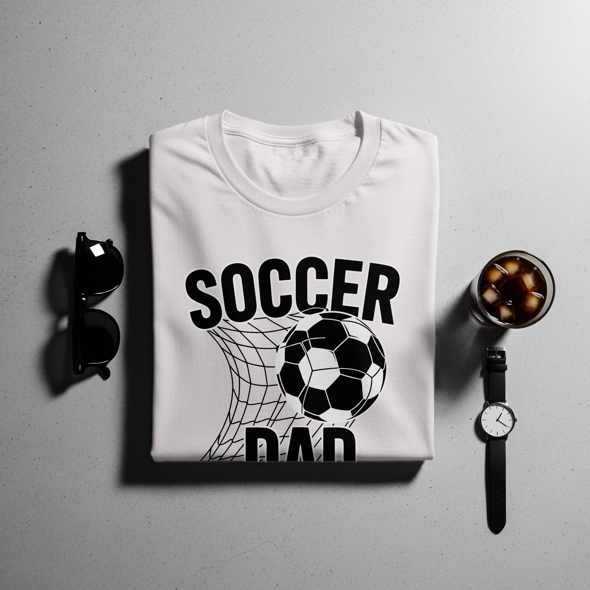 White t-shirt with "SOCCER DAD" graphic, a soccer ball, and net.