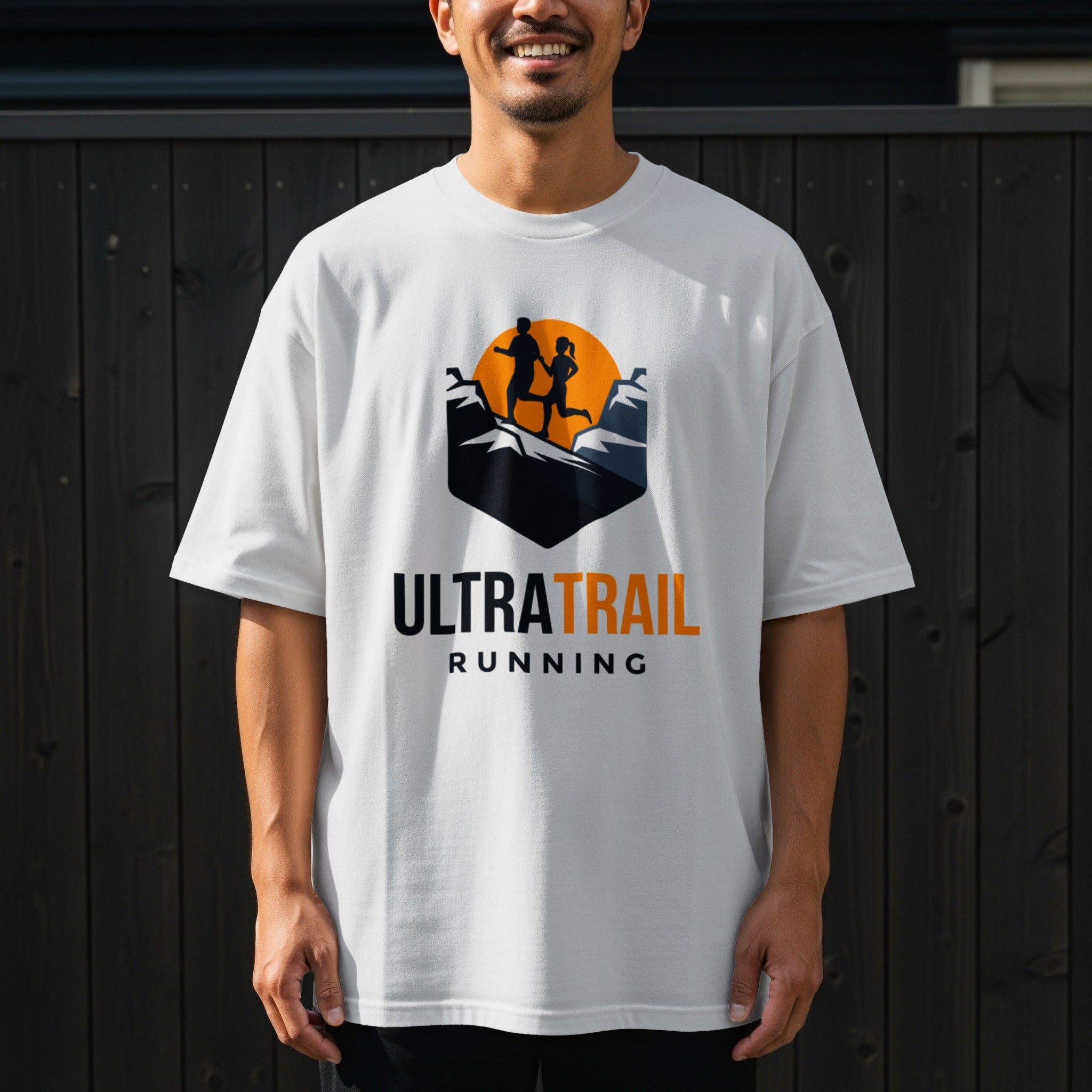 White t-shirt with "ULTRA TRAIL RUNNING" logo featuring silhouettes of runners on mountains.