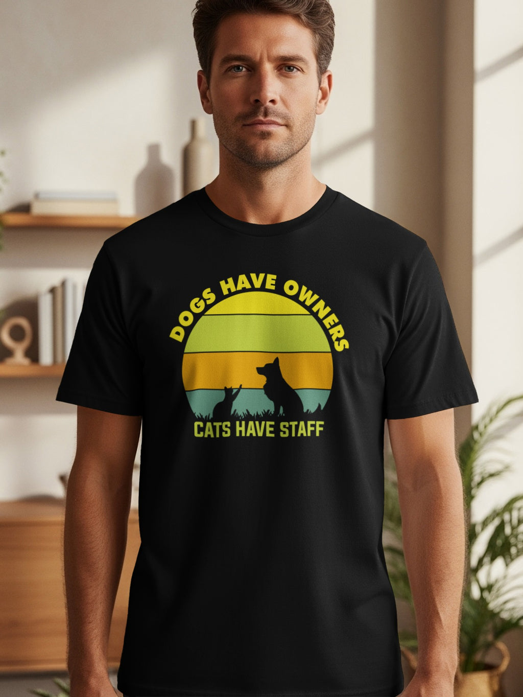 Black t-shirt with yellow text "Dogs Have Owners" and silhouette of dog and cat.