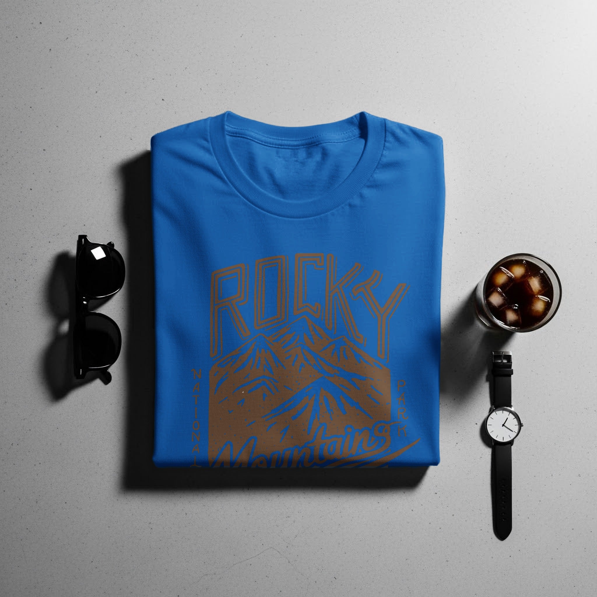 Blue t-shirt with "Rocky Mountains National Park" graphic and accessories.