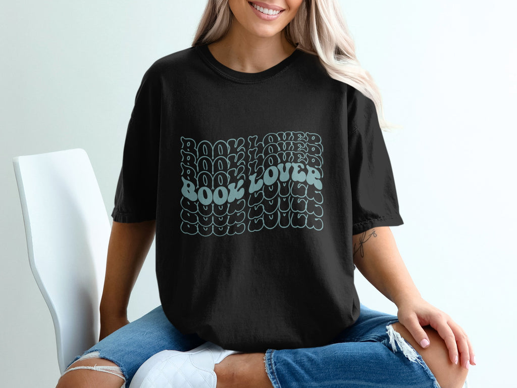 Black t-shirt with a retro aqua text design that says "Book Lover" repeated.