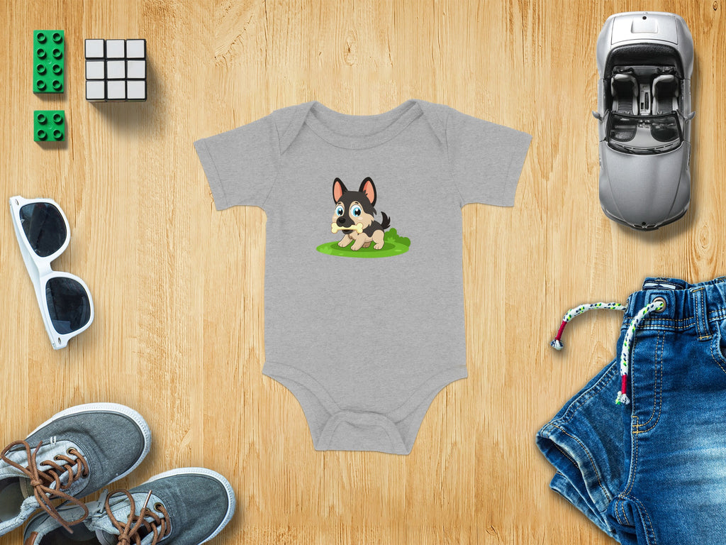 Gray baby onesie with cartoon dog holding bone, surrounded by toys and accessories.