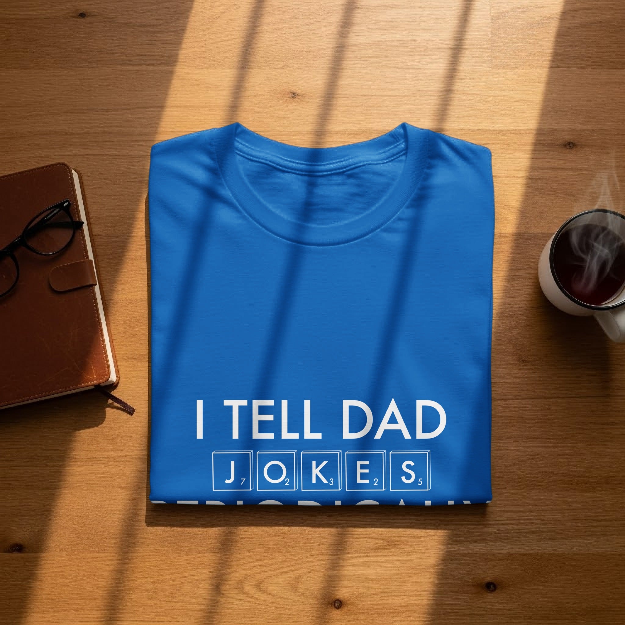 Blue t-shirt with "I TELL DAD JOKES" in white letters and Scrabble tiles.