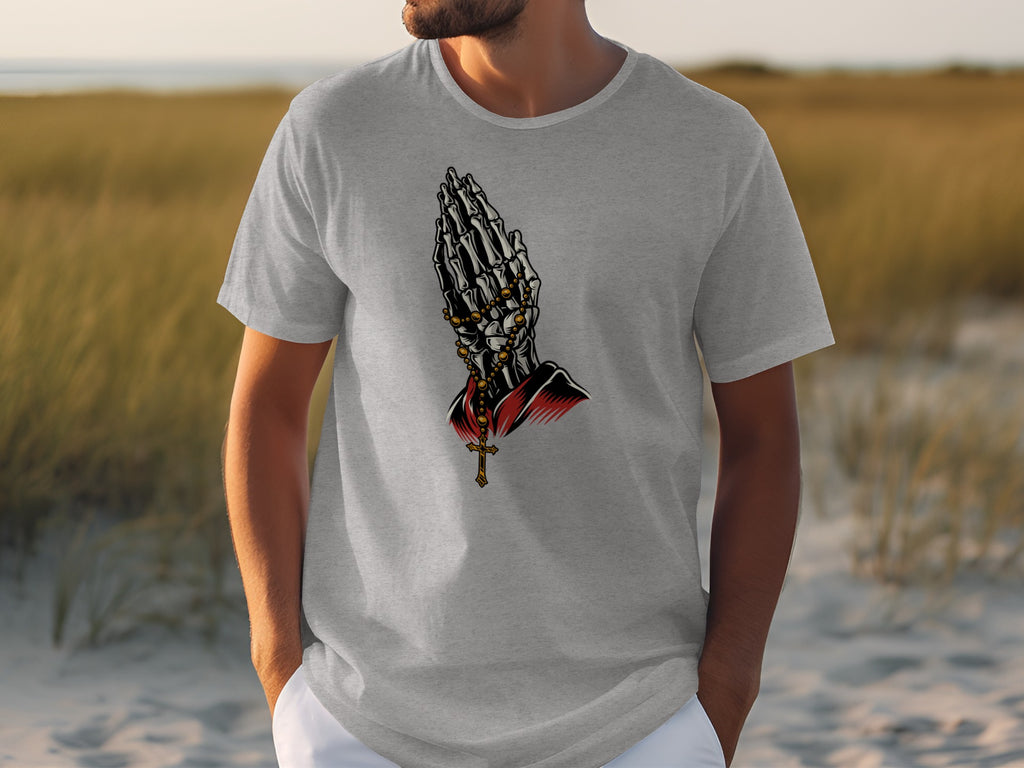 Grey t-shirt with skeleton hands praying and a cross necklace graphic.