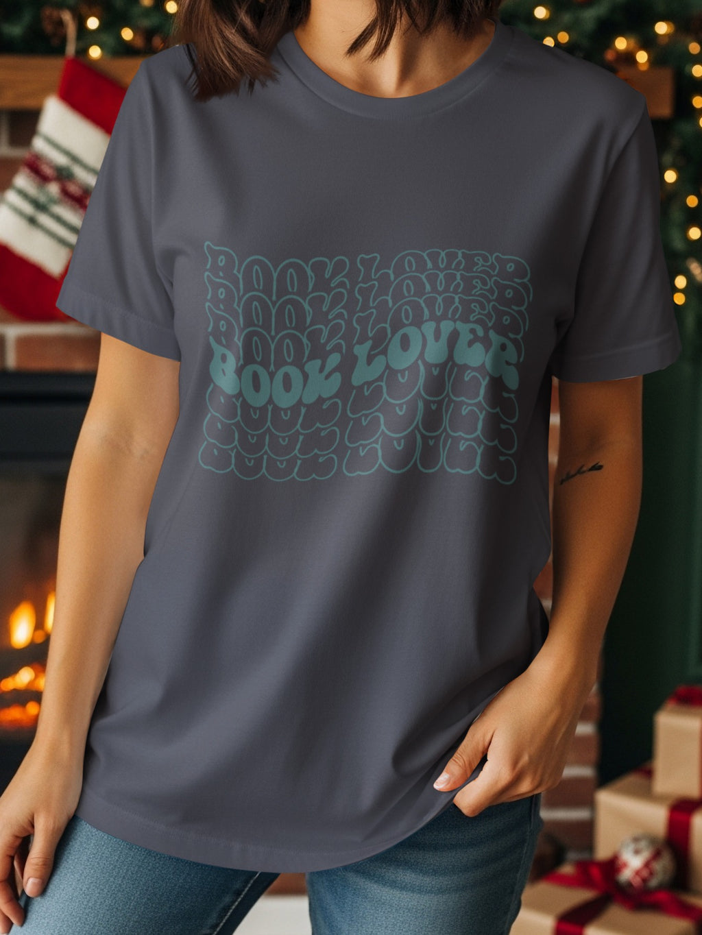 Dark gray t-shirt with repeating wavy text "BOOK LOVER" in teal.