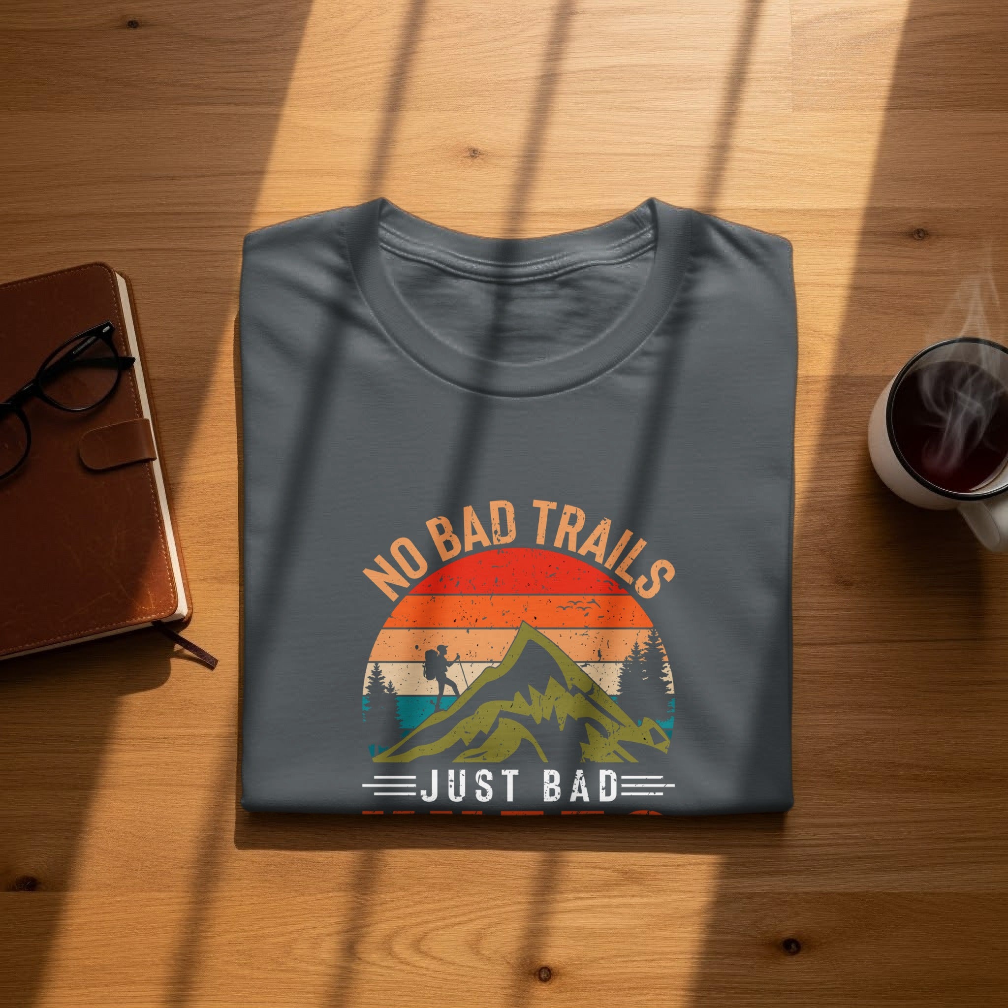 Grey t-shirt with mountain graphic and text "NO BAD TRAILS JUST BAD".