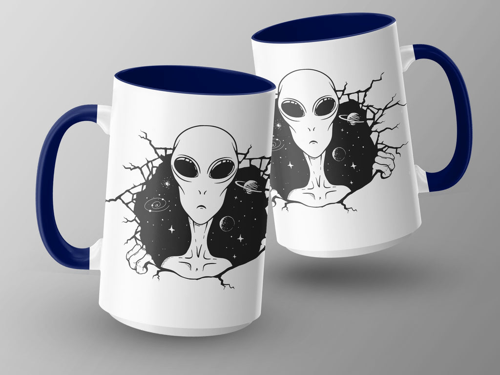 Two white mugs with dark blue handles and rims, featuring alien and space designs.