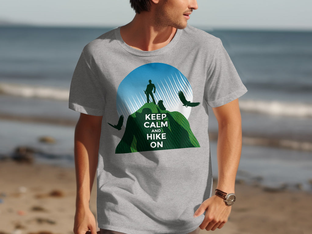 Grey t-shirt graphic with hiker on mountain, birds, and text "KEEP CALM AND HIKE ON".