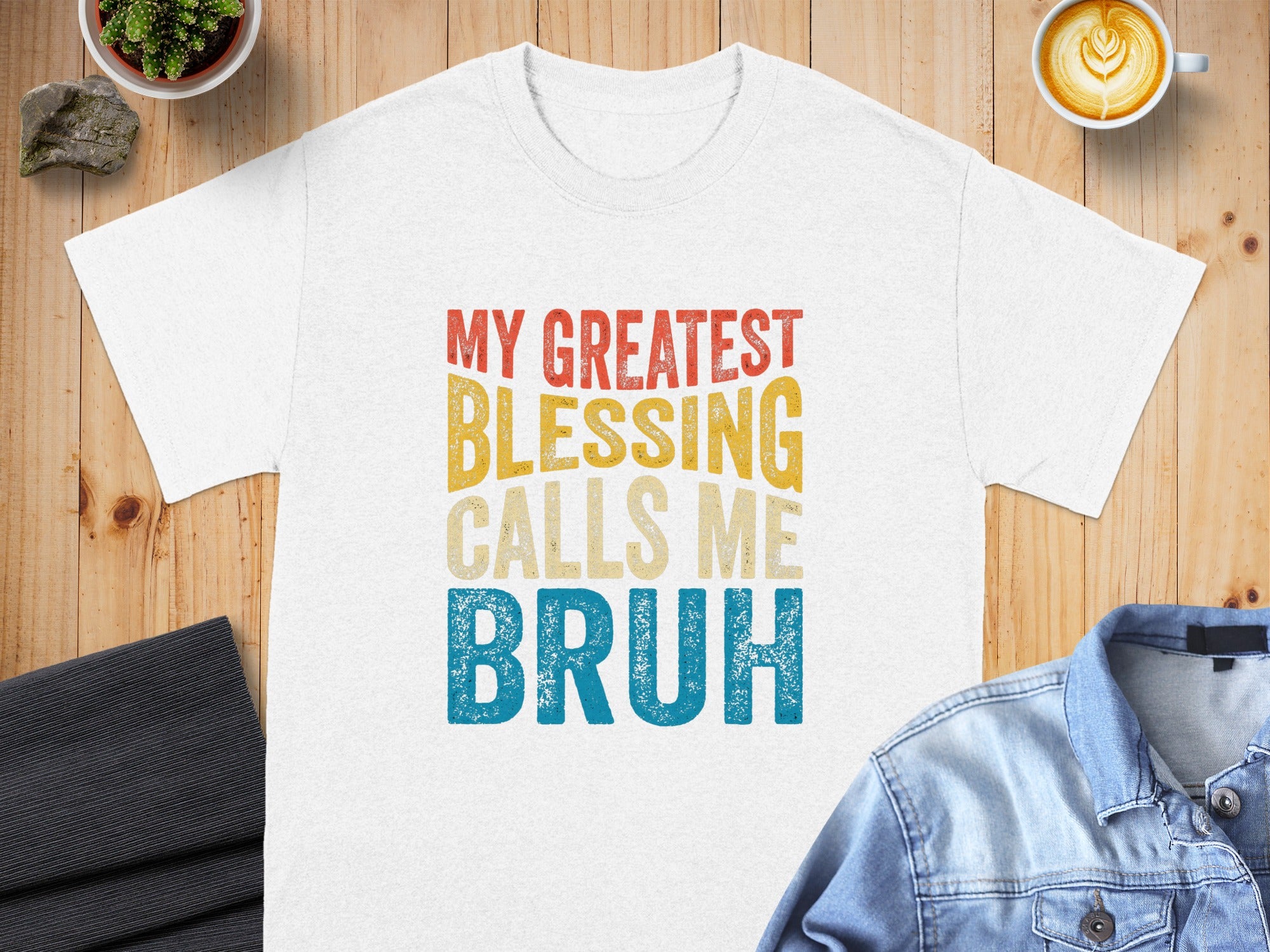 White t-shirt with "MY GREATEST BLESSING CALLS ME BRUH" text.
