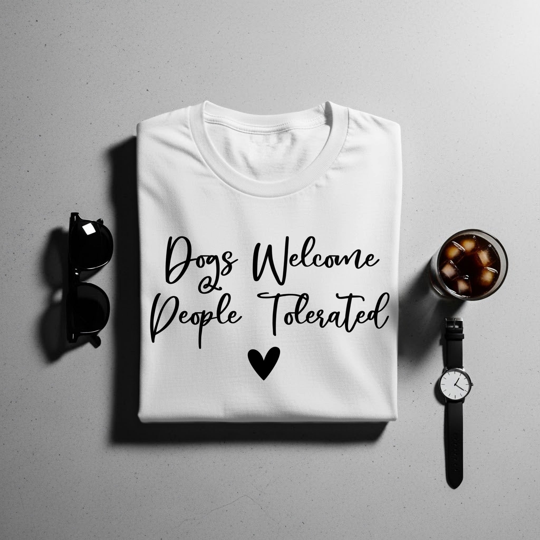 White t-shirt with "Dogs Welcome People Tolerated" text and a heart.
