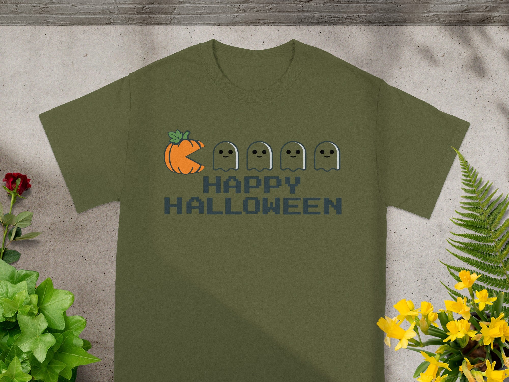 Olive t-shirt with pixelated pumpkin, ghosts, and "HAPPY HALLOWEEN" text.