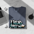 Blue t-shirt with graffiti text "I READ PAST MY" and an open book.