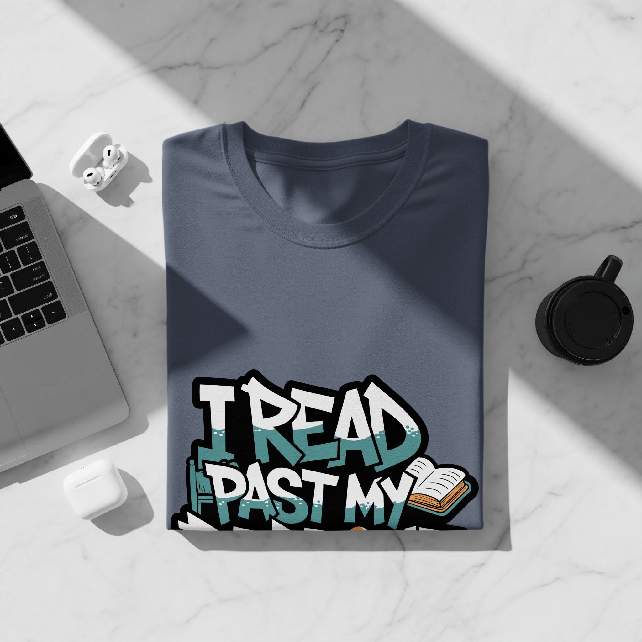 Blue t-shirt with graffiti text "I READ PAST MY" and an open book.