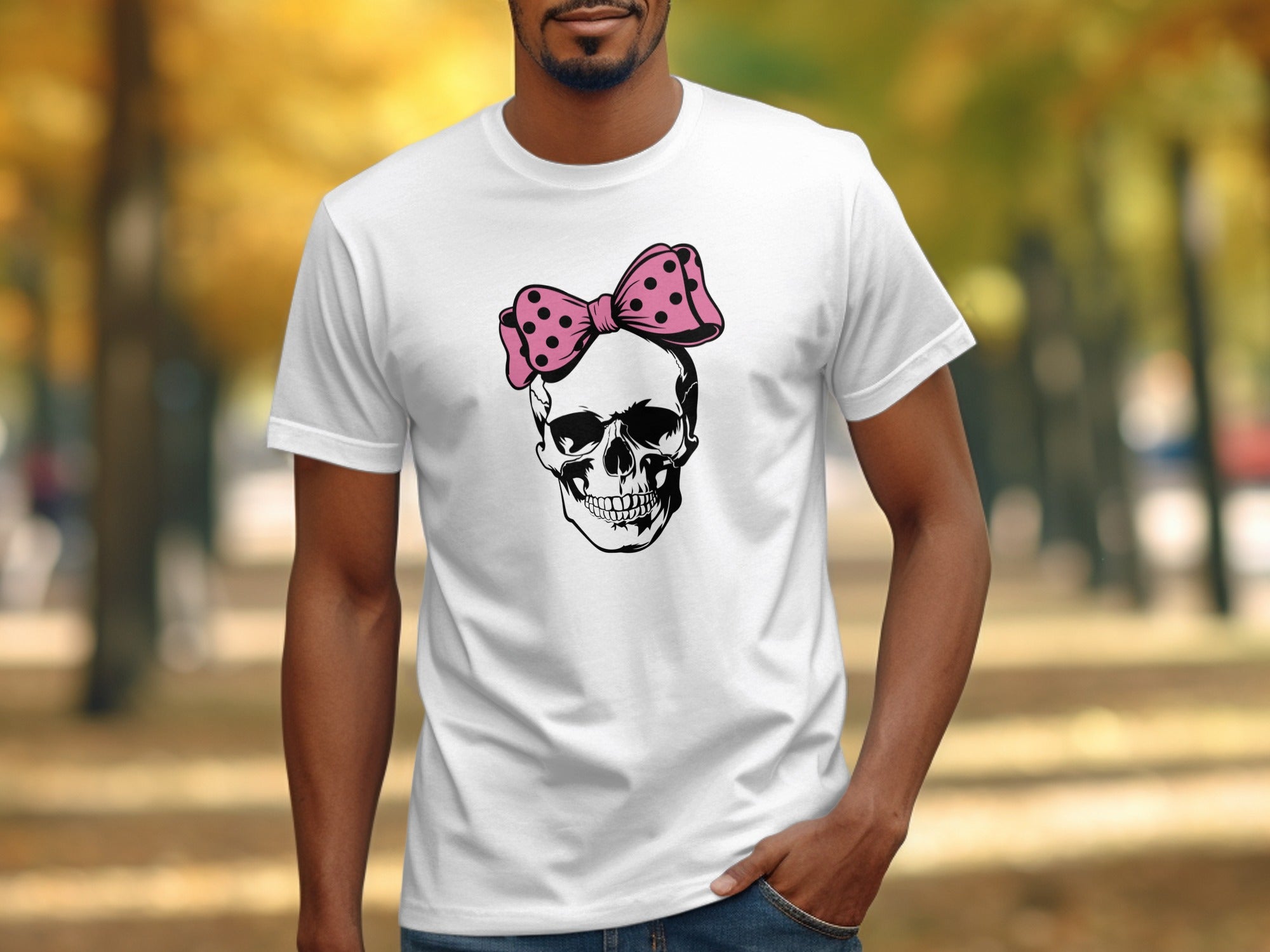 White t-shirt with a black skull wearing a pink polka dot bow graphic.