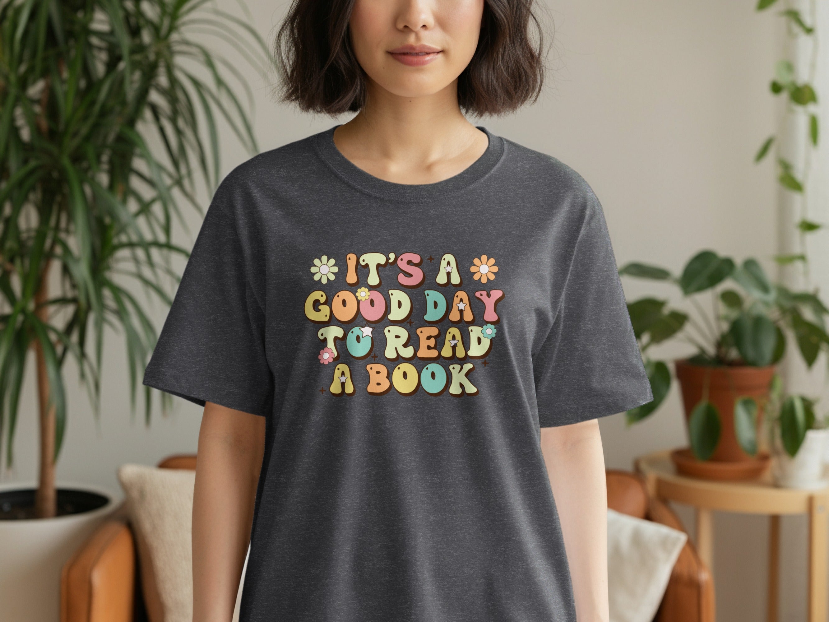 Dark grey t-shirt with colorful retro text "It's a good day to read a book".