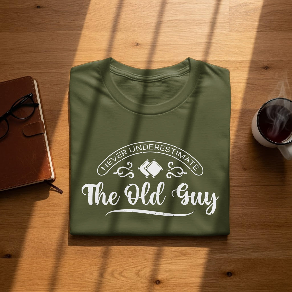 Olive green t-shirt with "Never Underestimate The Old Guy" text