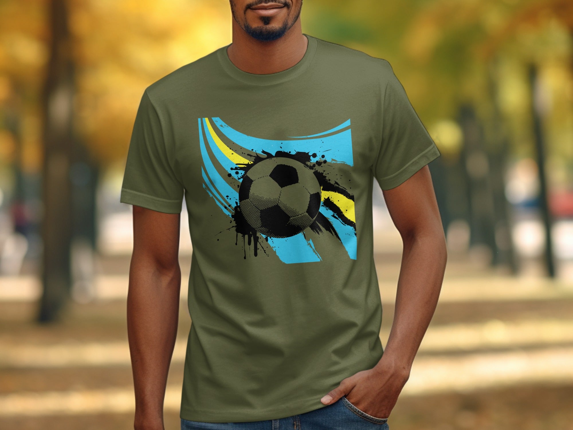 Man wearing olive green t-shirt with soccer ball and abstract flag graphic.