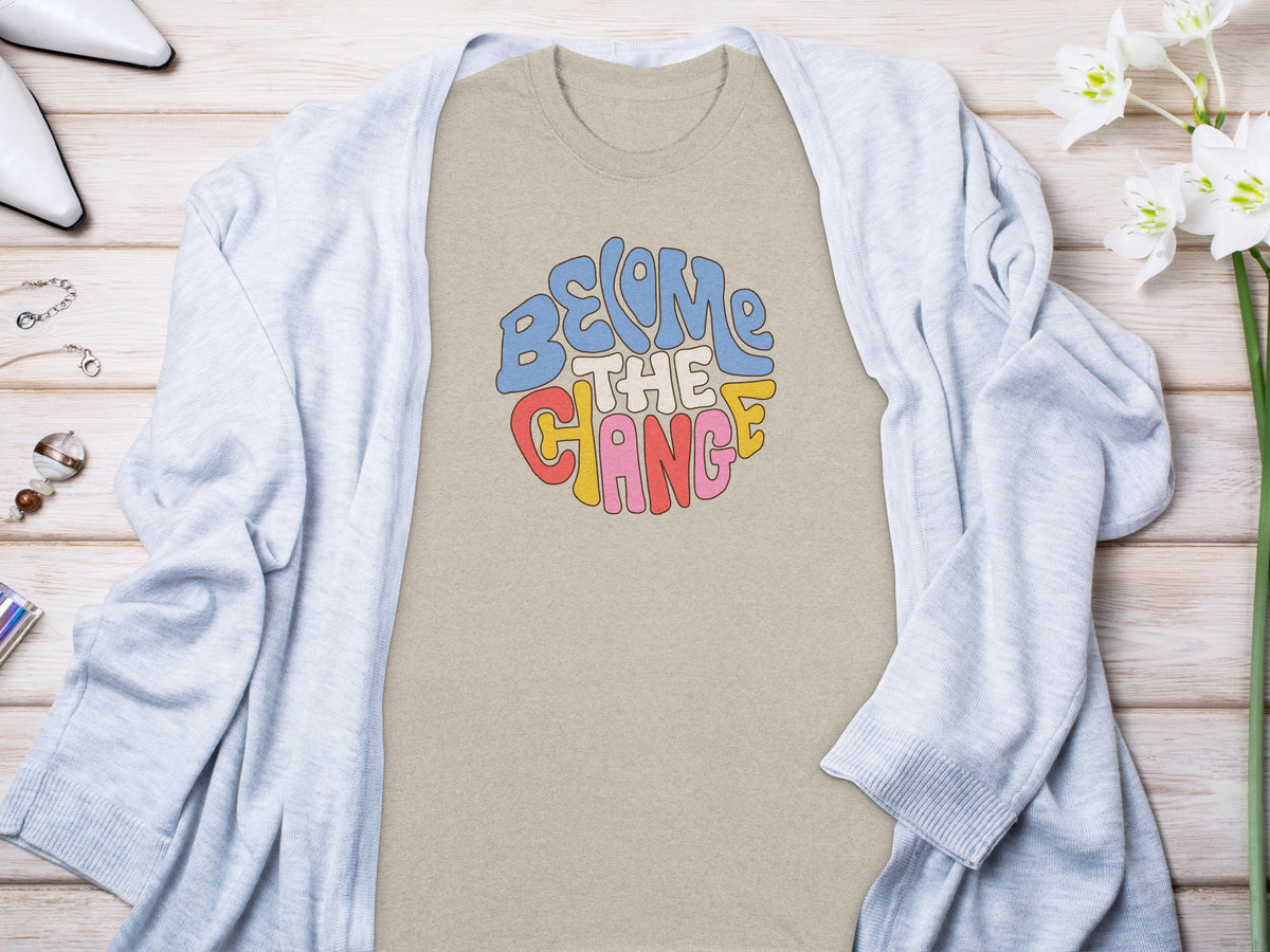 T-shirt with groovy "Become The Change" text in colorful lettering.