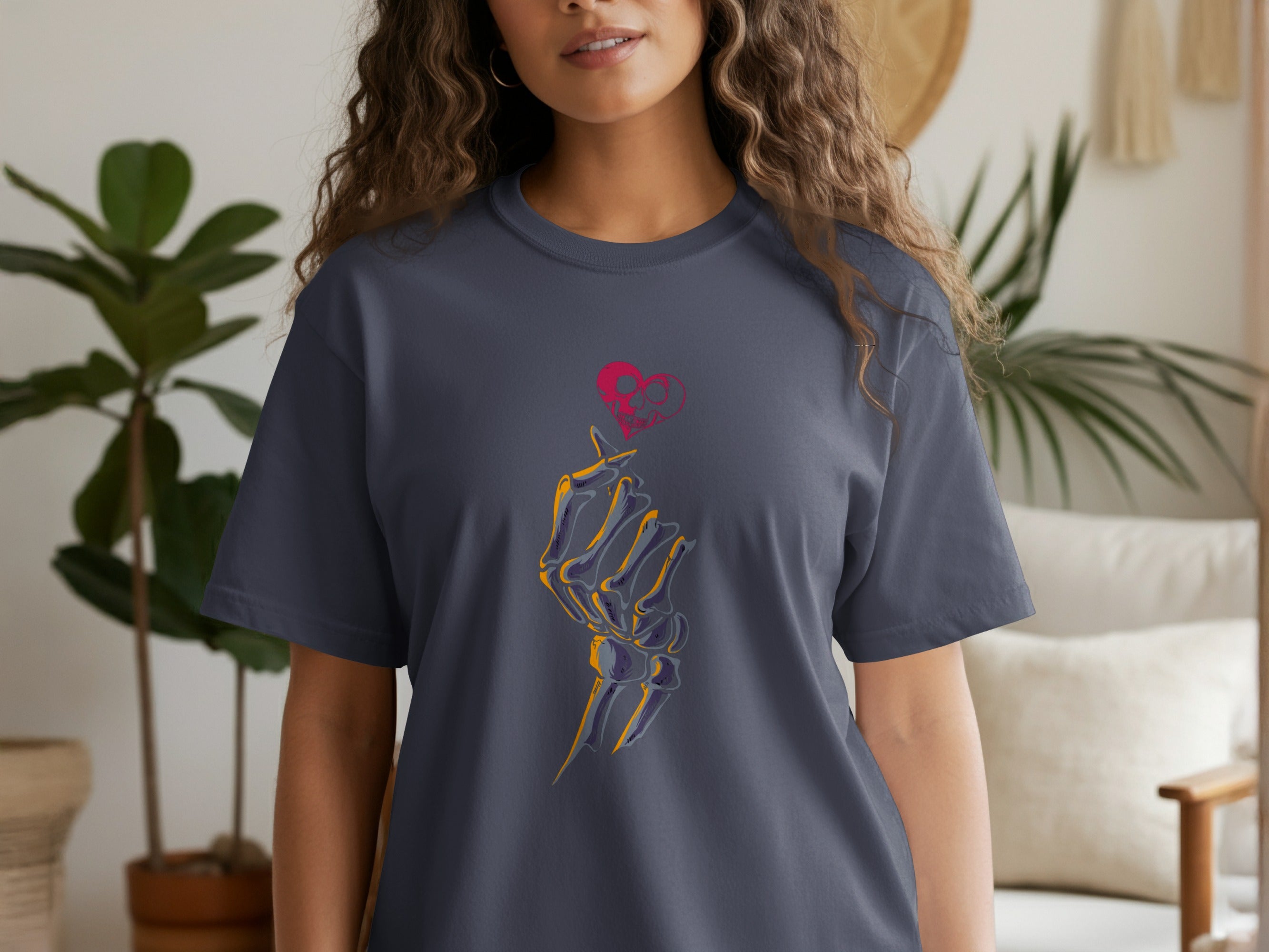Dark grey t-shirt with a skeleton hand forming a heart with a skull inside.