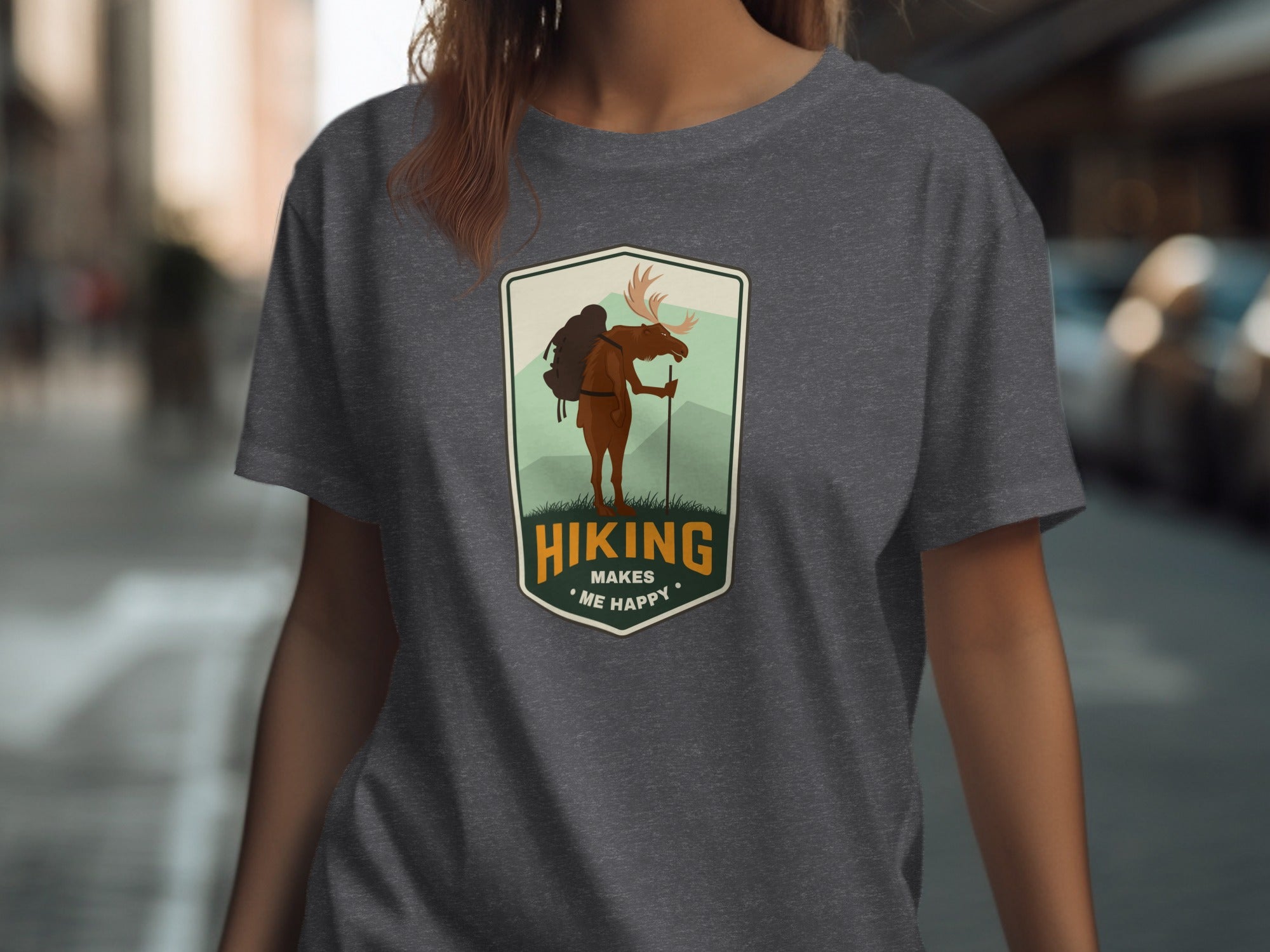Embroidered patch graphic of a moose on a shirt with text "Hiking Makes Me Happy".