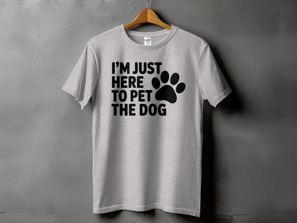 Light grey t-shirt with black text "I'M JUST HERE TO PET THE DOG" and a paw print.
