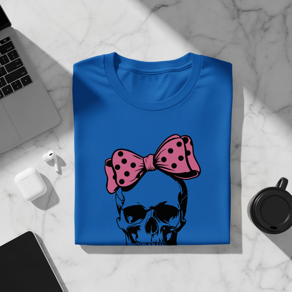 Blue t-shirt with black skull and pink polka dot bow graphic.