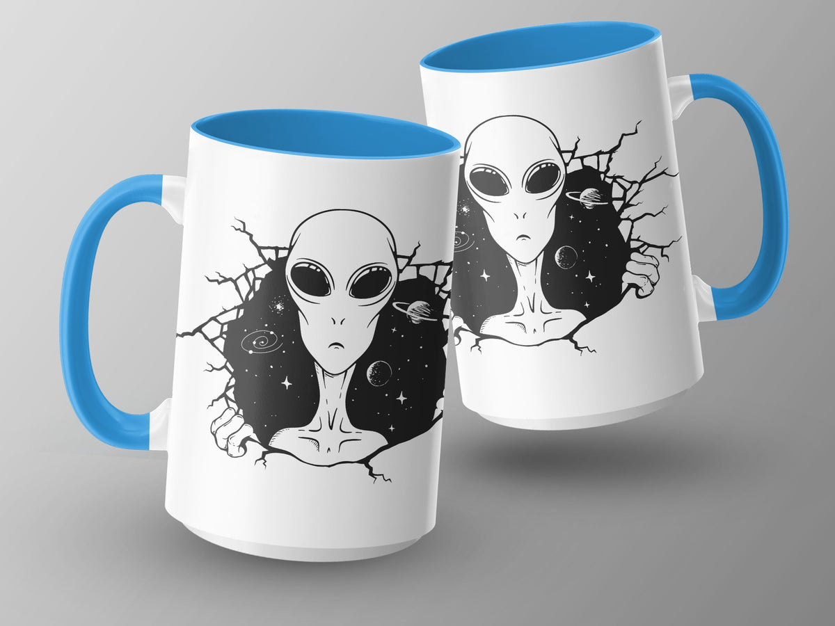 White mugs with blue handles featuring a cracked-open design revealing aliens and space.