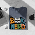 Gray t-shirt with "Book Nerd" text and a book with glasses graphic.