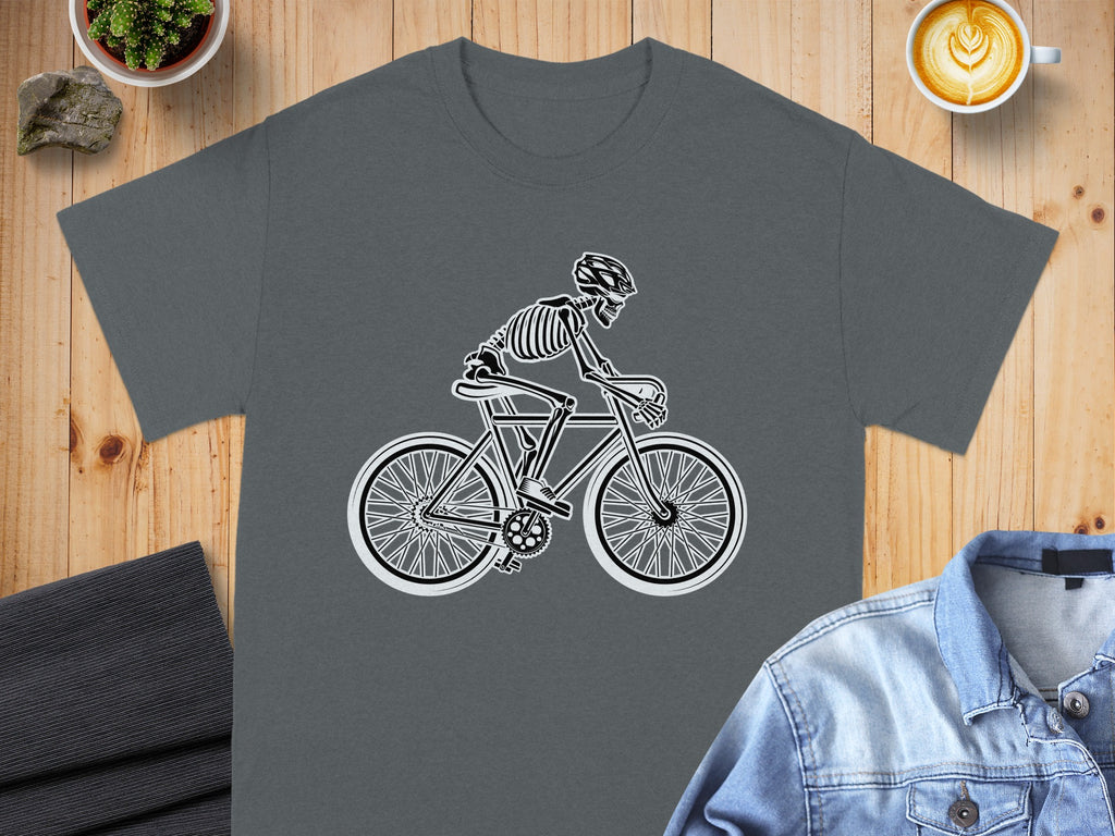 Skeleton cyclist graphic on a dark gray t-shirt with a black line drawing.