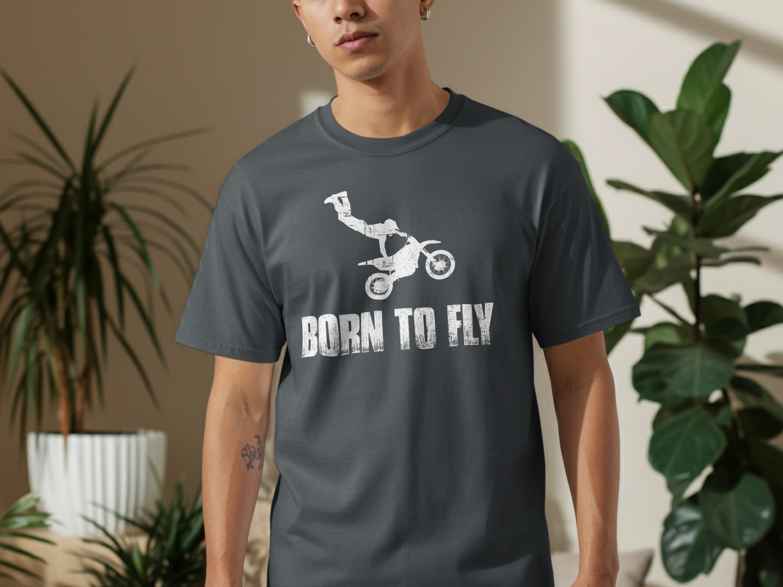 Dark grey t-shirt with distressed white graphic of dirt bike rider and text "BORN TO FLY".