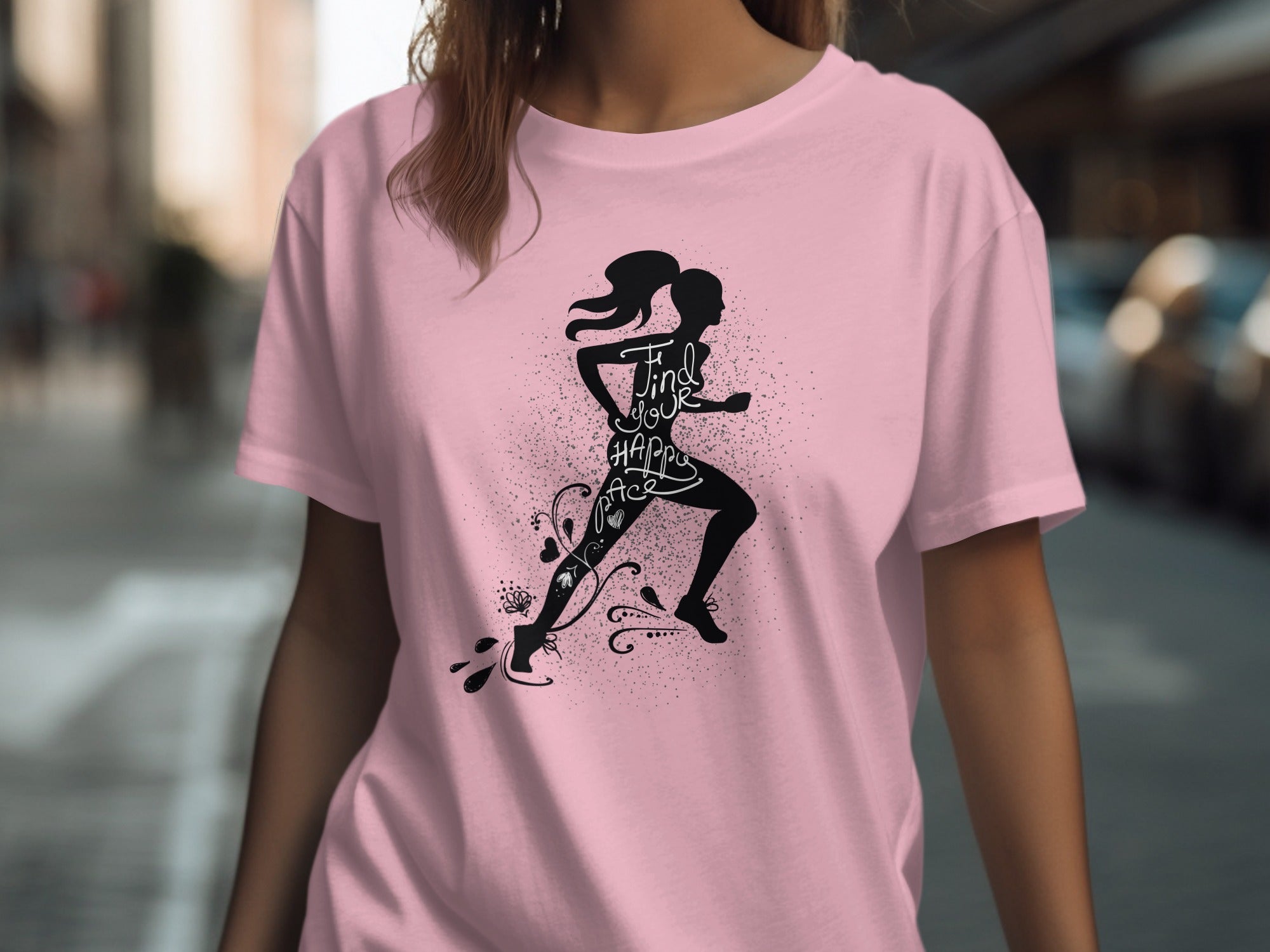 Pink t-shirt with black silhouette of a runner and the text "Find your happy pace".