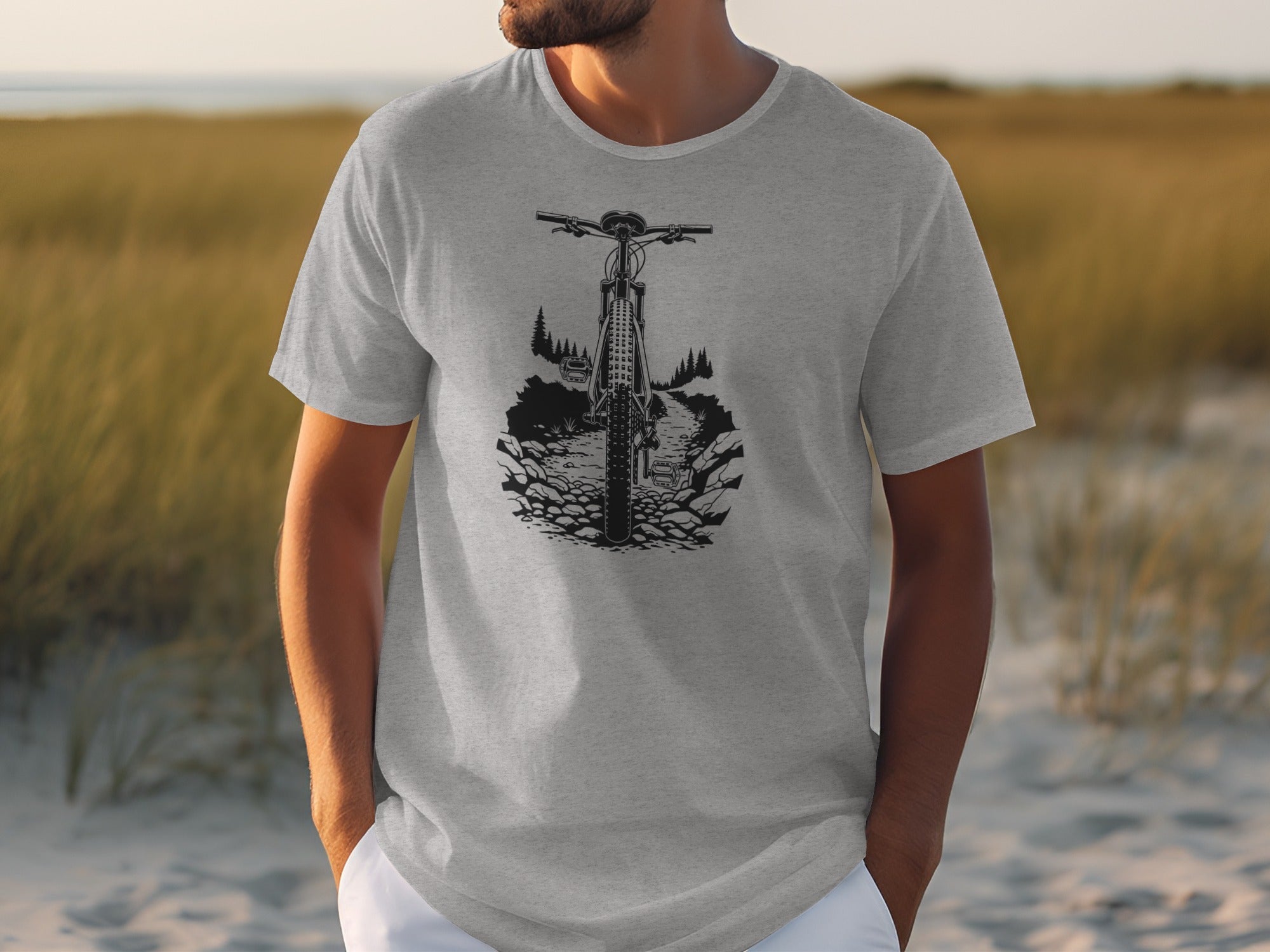 Grey t-shirt with a black graphic of a mountain bike on a rocky trail.