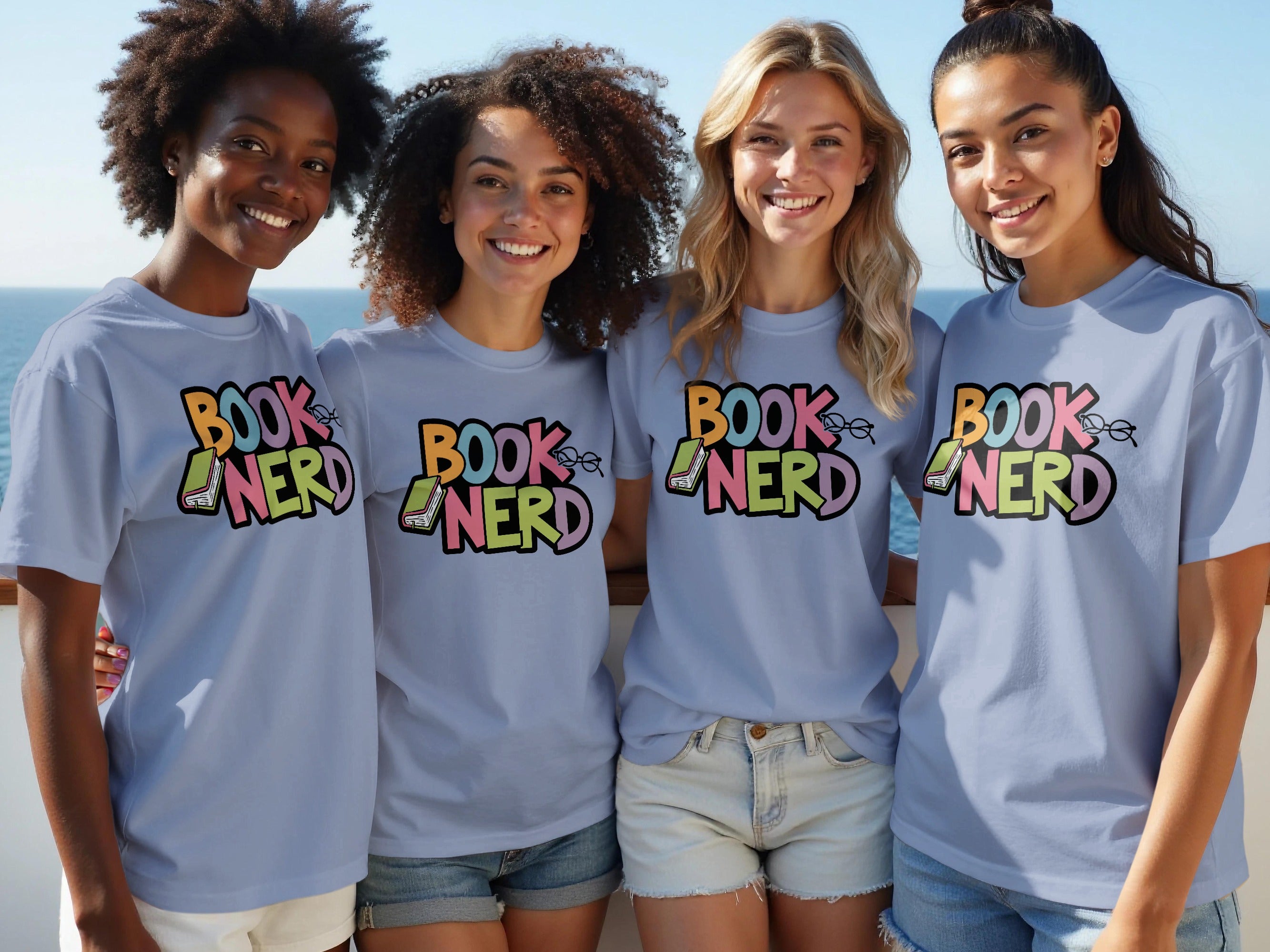 Four women wearing light blue t-shirts with "BOOK NERD" graphic and book illustration.