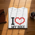 White t-shirt with "I ❤️ MY BIKE" text and a bike chain heart graphic.