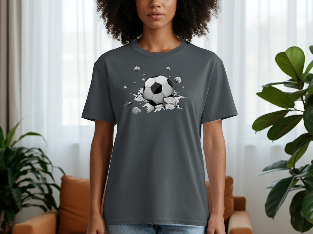 Gray t-shirt with a graphic of a soccer ball breaking through a surface.