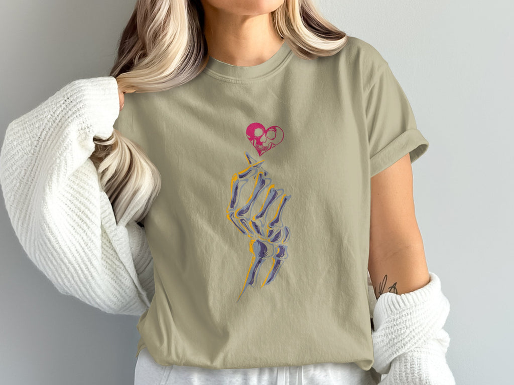 T-shirt with skeleton hand, pink skull heart, and purple blue graphic.