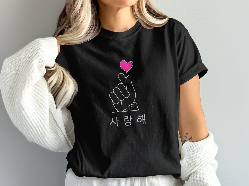 Black t-shirt with pink heart finger gesture and Korean text.