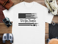 White t-shirt with black American flag design featuring guns and "We the People" text.