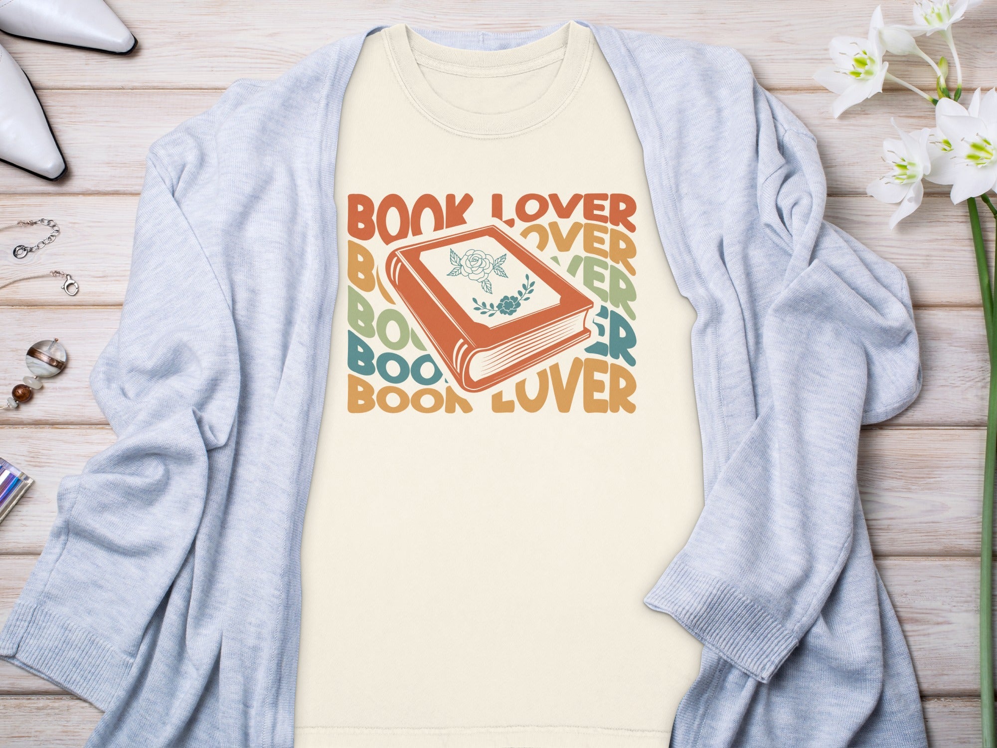 T-shirt with "Book Lover" text and a graphic of an open book with a rose design.