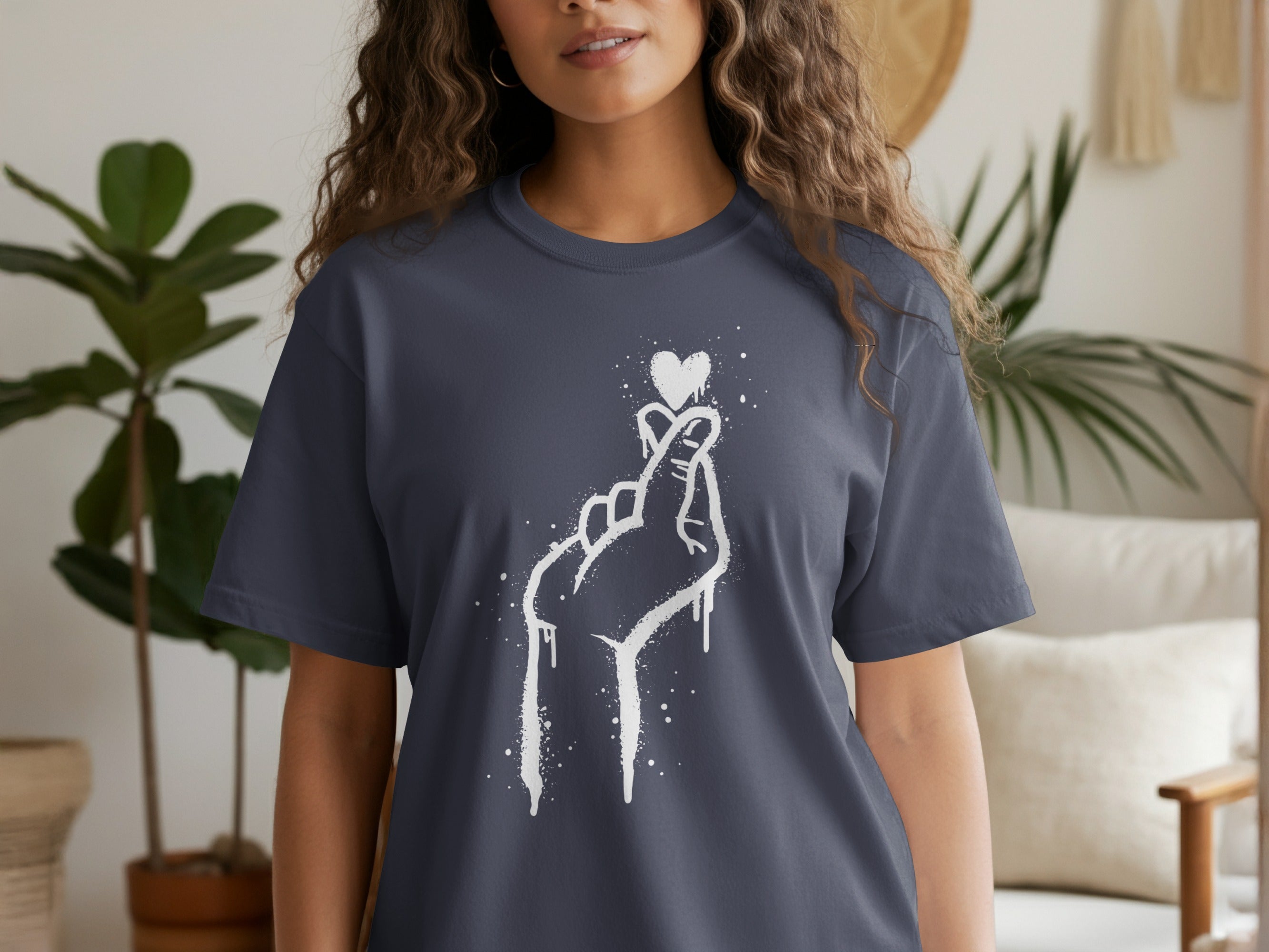 Dark blue t-shirt with white graffiti-style heart finger gesture graphic.