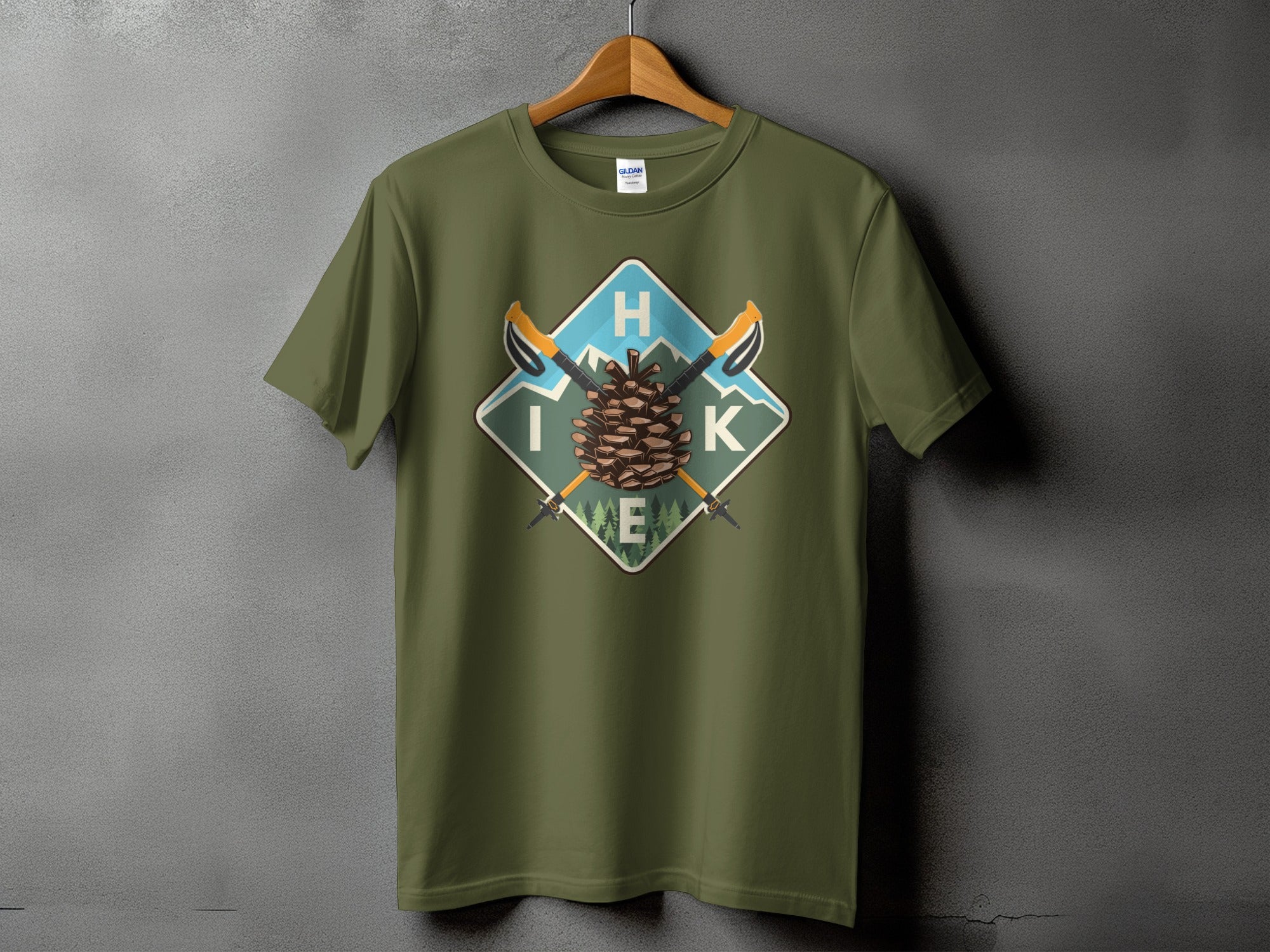 Green t-shirt with diamond graphic featuring pinecone, mountains, and the word "HIKE".