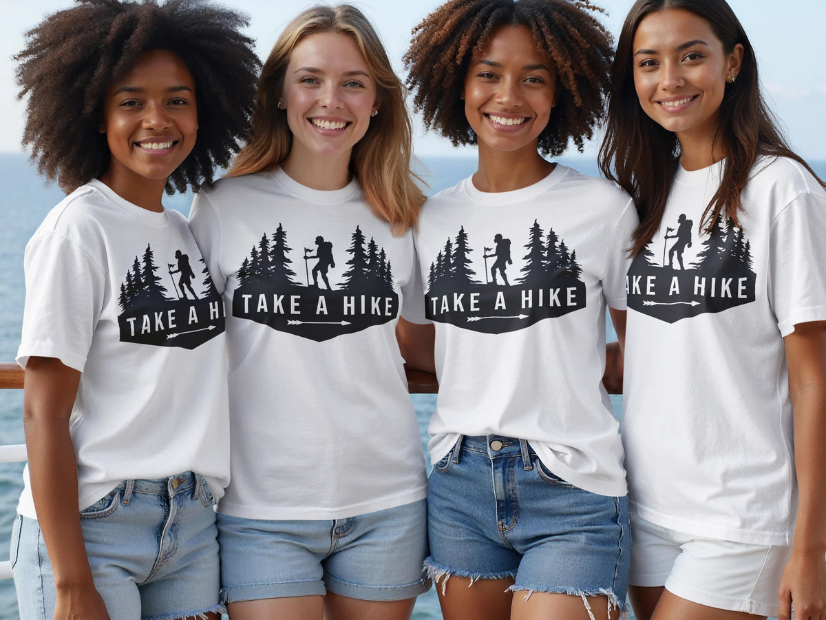 Four women in white t-shirts with "TAKE A HIKE" and a forest graphic.