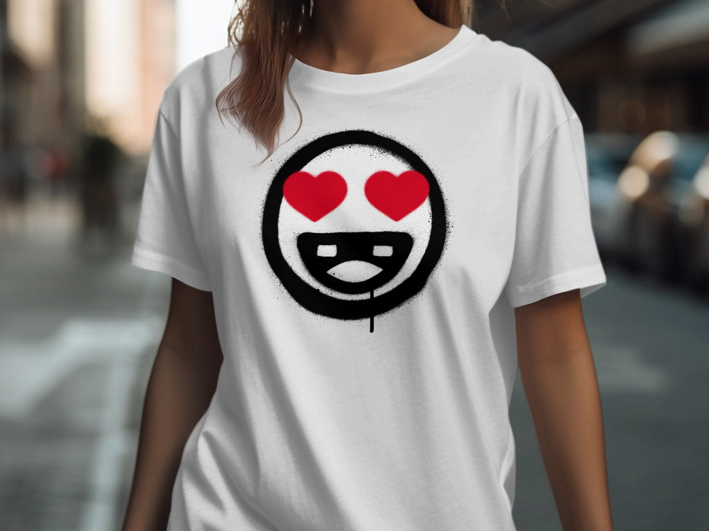 White t-shirt with a black circle graphic containing two red hearts and a smiling mouth.