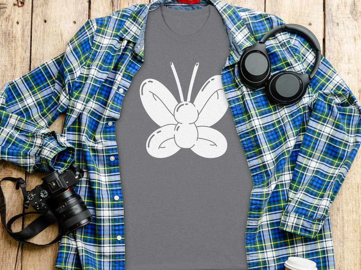 Gray t-shirt with white balloon butterfly graphic, plaid shirt, headphones, and camera.