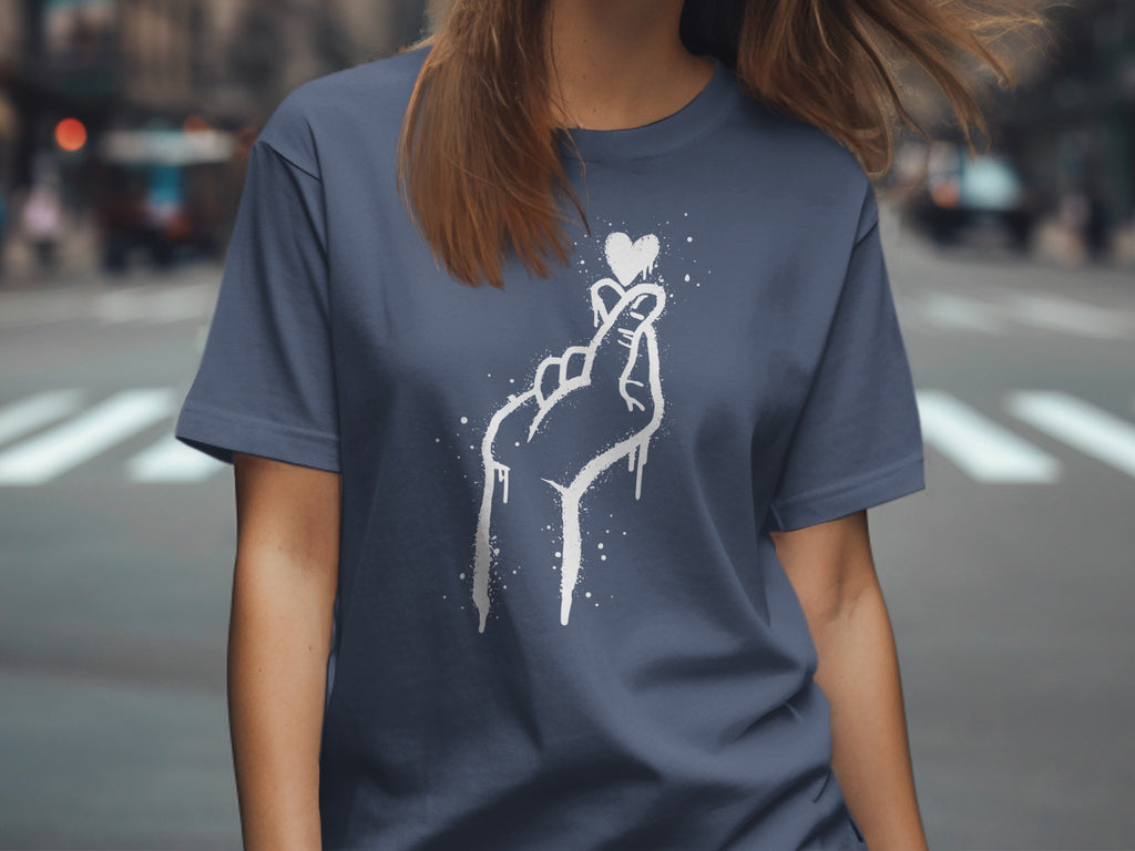 Blue t-shirt with a white spray-paint heart-shaped finger heart design