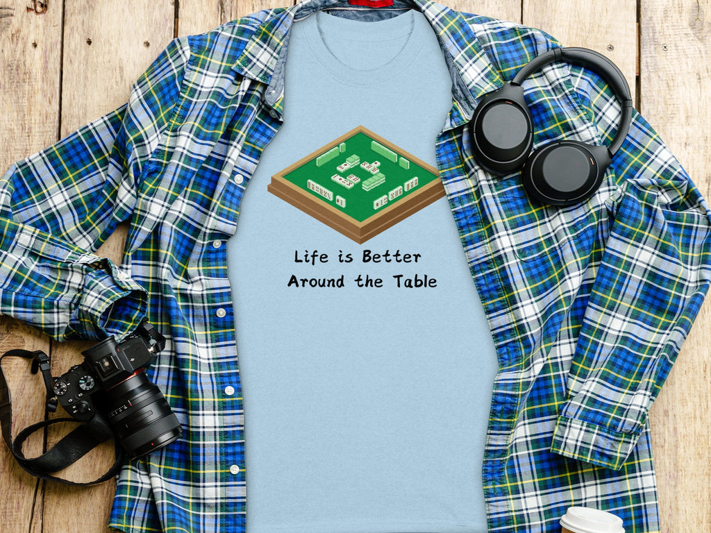 Light blue t-shirt with Mahjong set graphic and text "Life is Better Around the Table".
