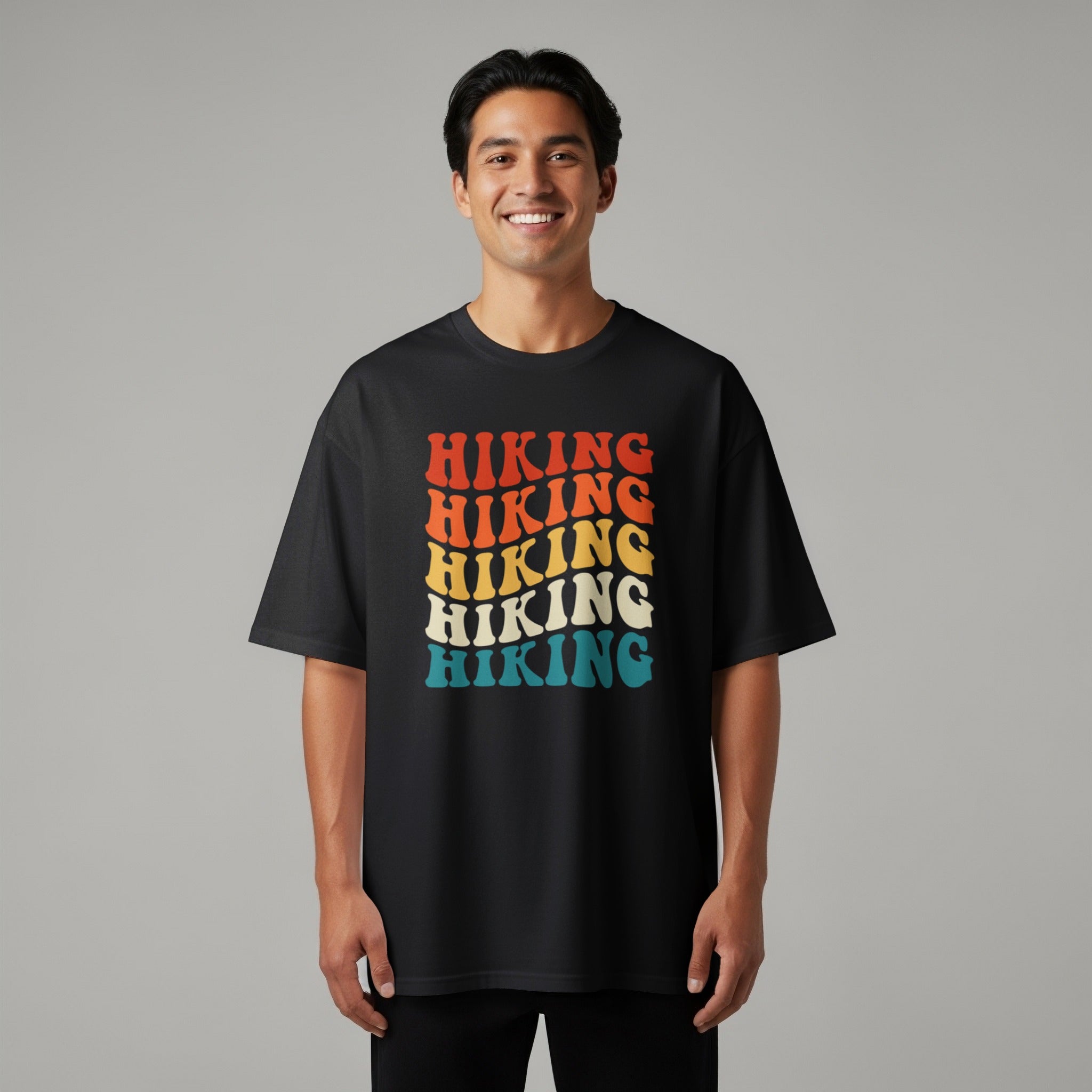 Black t-shirt with repeated "Hiking" text in retro wavy font colors.